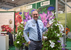 Andy Jeanes of Guernsey Clematis / Raymond Evison Clematis next to Guernsey Flute EviGsy153 (PBR). Behind him the 3 novelties: Clematiss Baroness Fookes EviGsy156(PBR) Clematiss Bridgewater EviGsy155(PBR) Clematis Elpis EviGsy154(PBR)