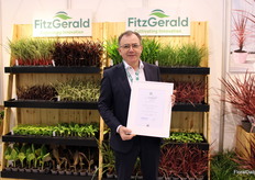 Pat FitzGerald of FitzGerald Nurseries proudly displays the Novelty Award they won for Ficus carica Fignomenal
