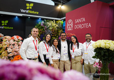 The team of VerdNatura and Santa Dorotea in their shared booth full of roses and other beautiful flowers