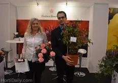 Ghita Krage and Mario Kurt Gigerl from Poulsen Roser holding a new pot rose variety and an indoor clematis.