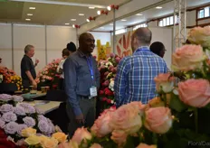 Gilbert Gathu of Harvest Limited Talking with a visitor.