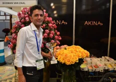 Arfhan Mughal of Fontana holding the Platinum Best Flower Quality Award (Growers-Roses).