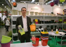 Adrien Cohu, a French manufacturer of pots, holding a nursery container with a new color.