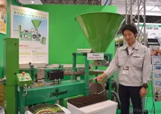 Kunishi Yoshitaka of Iwatani Group. This group imports machines. He stands in front of the Ellegaard machine which is produced in Denmark.