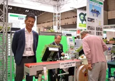 Hiromitsu Muraoka of Iwatini Group, standing behind one of his imported machines. These machines will be sold to the Japanese growers.