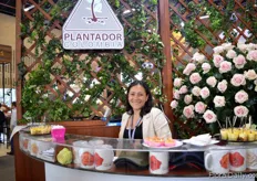 Ana Lucia Benavies of Plantador. THey are rose breeders and are called in Plantec in Ecuador. She is sitting next to the Pink Mondial, which is a popular rose to grow.