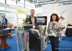 Mark Militor and Dominique Kooij of MecaFlor standing nect to the EOS sleeving machine. This machine sleeves orchids, it has a minimum of 900 cycles per hour. According to Kooij, the machine has two major advantages; it will decrease absence through illness and the orchids can be sleeved together with a pot.