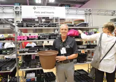 Timothy S. Allen of East Jordan plastics holding their new 14 inch planter. This planter is available in 6 different colors. These containers are supplied to the growers. According to Allen, consumers are looking for more patio ready material.