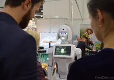 The robot shows a video where people can view the 18ha greenhouse in Russia. Besides that, the robot also answered questions of the visitors.