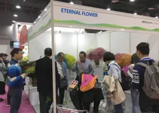 Adrian Moreano of Eternal Flower talking with visitors.