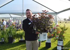 Mark Osgerby of Proven Winners holding the Winecraft Black. It is the first Proven Winners Smokebush. It is an easy to grow plant and manageable plant that stays tight.