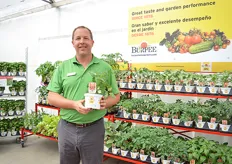 Scott Mozingo of Burpee holding the Beefsteak Tomato Oh Happy Day. is new concept in tomatoes with an disease-resistance package. It produces a crop of 5 to 6-oz. indeterminate beefsteak tomatoes in clusters of 3 to 7 fruit. Resists Early Blight, Late Blight, Verticillium and Fusarium.