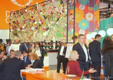 The crowded booth of Dümen Orange with a nice piece of flower art.