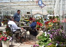 Visitors relaxing and discussing between the plants of Sakata.
