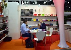 Dietrich Buchmuller of Pöppelmann TEKU talking with a visitor. They are exhibiting their products at the German pavillion.