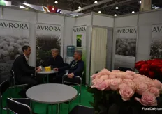 Alexander Grismen from Avrora having a conversation with two clients.