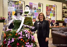 Gill Corless of Sakata next to the dress made out of Sunpatiens.