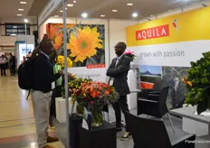 Seth Riungu of Aquila talking with visitors. They started out as a rose grower, but over the years, they started to grow more flowers and they are now able to make bouquets on source, something that is in high demand now.
