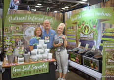Family Laskowski, from left to right; Brenda, Scott and L.Be. L.Be is holding their newest fertilizer, a liquid 3 in 1 fertilizers that fertilizes the crop and helps the grower to get rid of mildew and bugs.