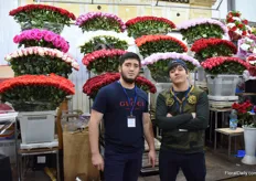 Two vendors standing in front of their Ecuadorian roses.
