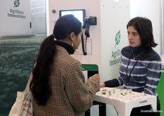 Anna Zsoldos explains to a visitor at ADI's booth. Also on display there was a video of a vase life test, aided by ADI cameras.