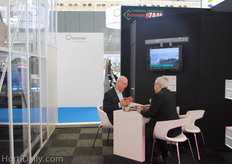 Henk Peek, Bosman Van Zaal, conversating with an acquaintance.