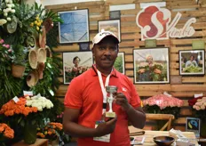 James Kanyari of Simbi Roses with their bronze award for best stand design in the perishables category. They grow roses in Thika.