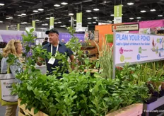 Andy Pollock of Netherlands Bulb Company talking with a visitor about their water plants. They also sell bulbs, perennials, pots and citrus to garden centers all over the US.