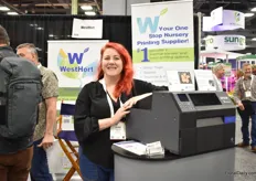 Jullie Hannah of WestHort with the Epsom 6500. An inject printer for thicker pot stakes. We are the only one on the industry that manufacture inject pot staMike and Mary McKenzie of Oglesby, a young plants producer. kes.