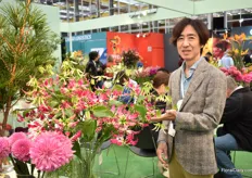 Kenichi Saito of Japan Flowers and Plants Export Association next to Gloriosa, a new color. Flower exports from Japan are growing every year with China and the U.S. as main markets.