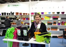 Isabelle Pavie of Soparco presenting some of their new products like, from left to right: square round container which can be filled with mulch with a machine due to the round shape and saves space on the trolley due to the square shape, a new plant support product, a window box which makes making combinations an easy task and pots with a print.